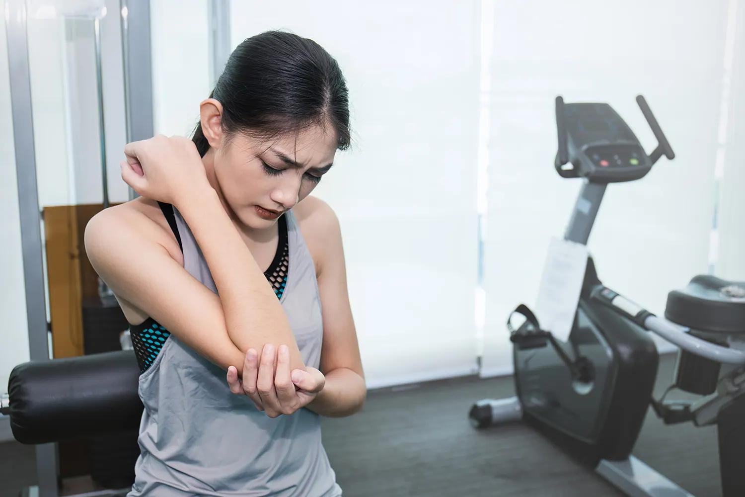 a woman suffering from arm pain after her workout