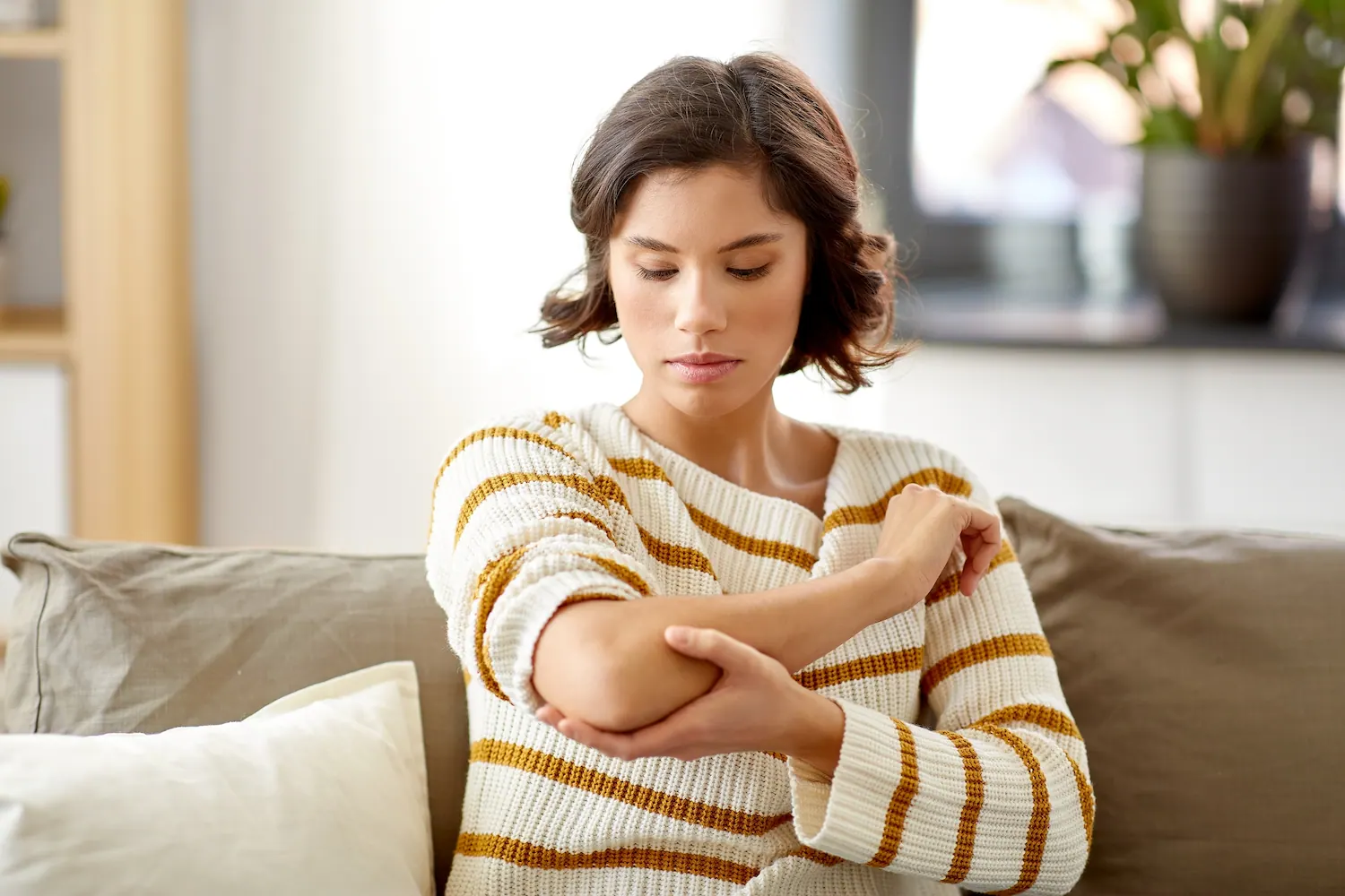 a woman touch her elbow pain