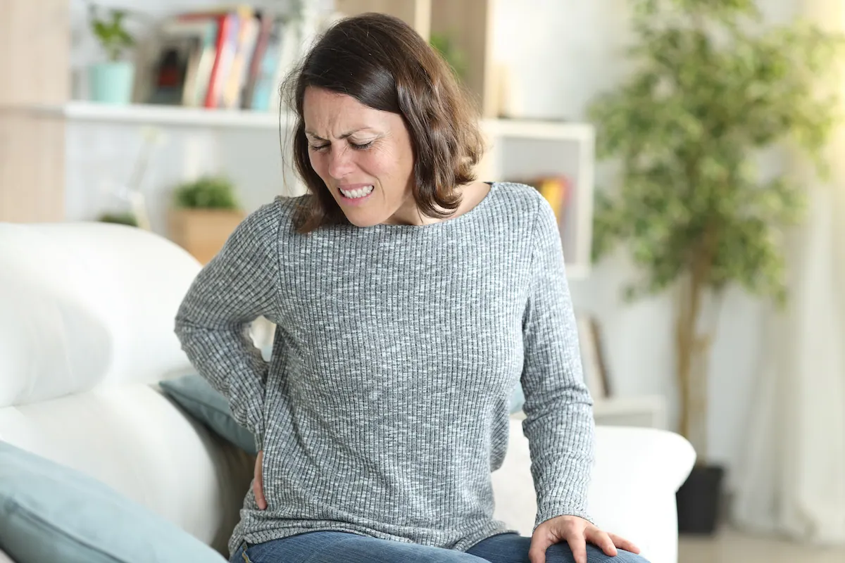 a woman suffering from lower back pain