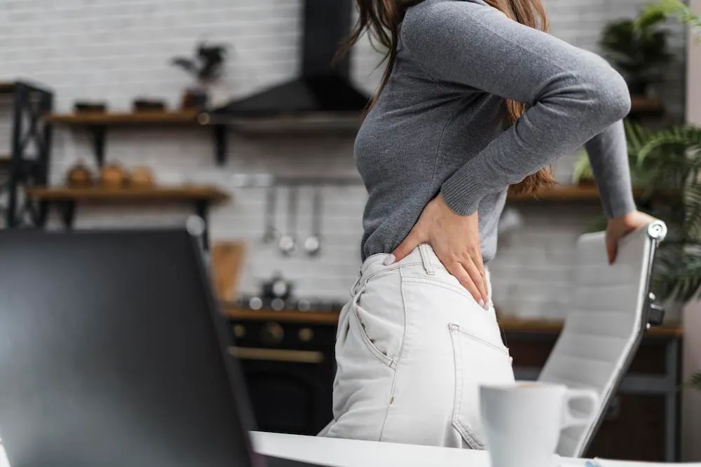 a woman suffering a lower back pain from Flexion Distraction
