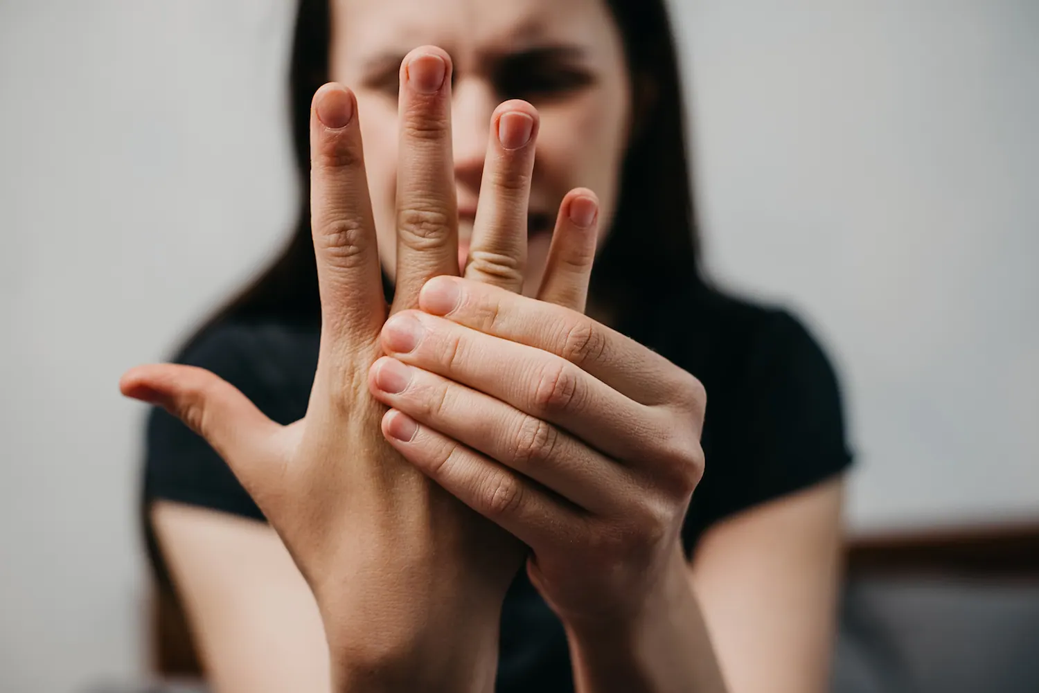 a woman suffering from neuropathy in fingers