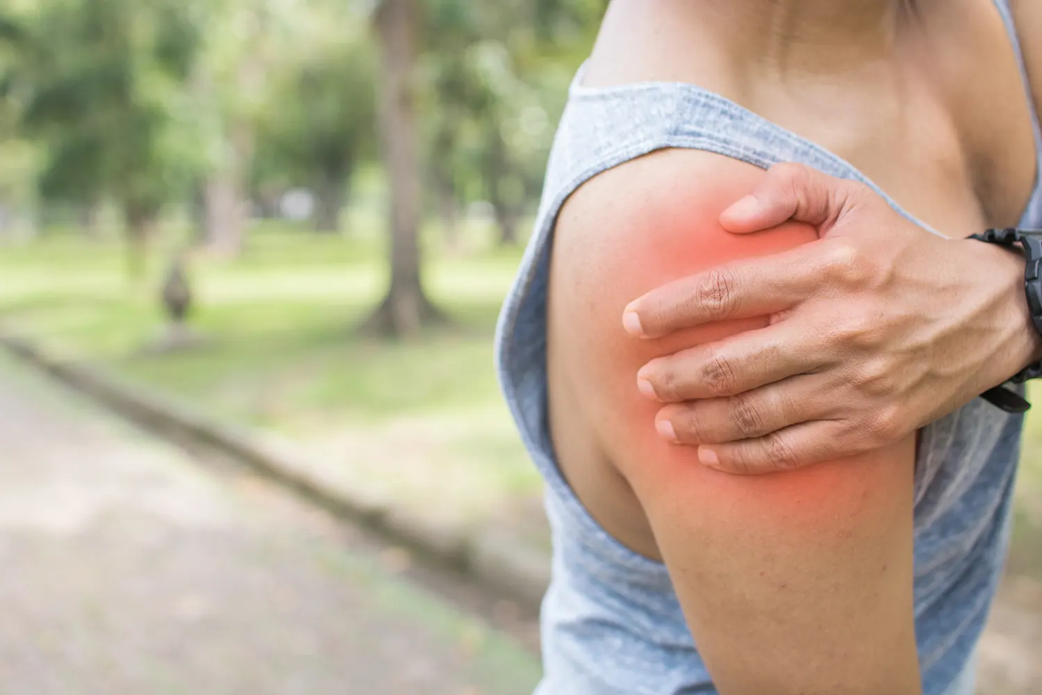 a woman suffering from shoulder pain after workout