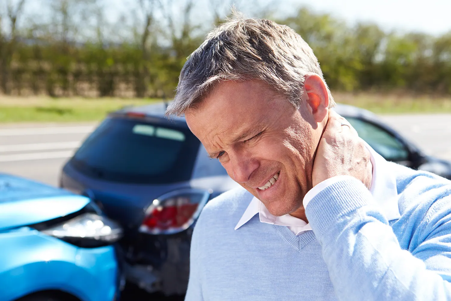 a old man having a neck pain from whiplash after accident