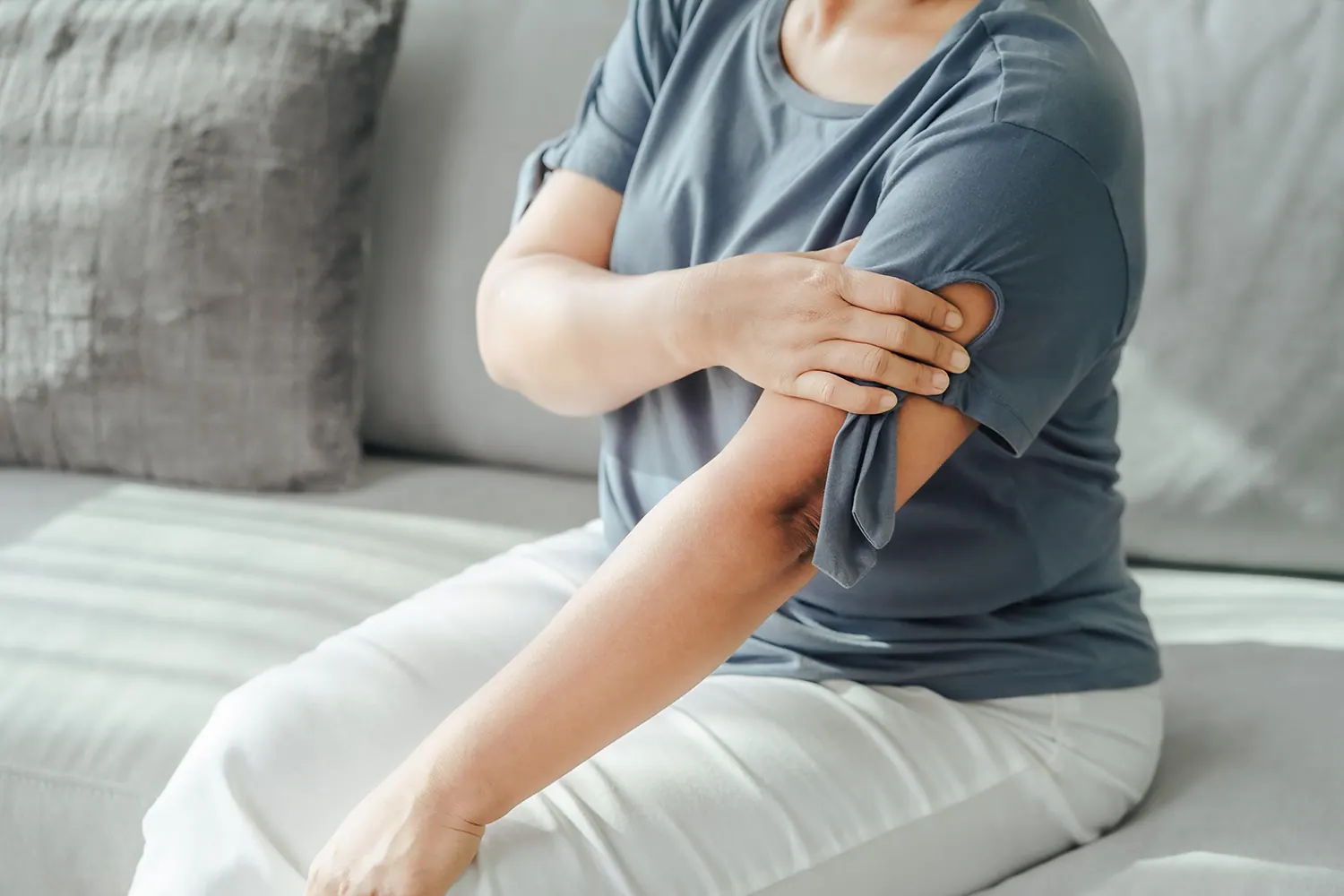 a woman touch her shoulder pain