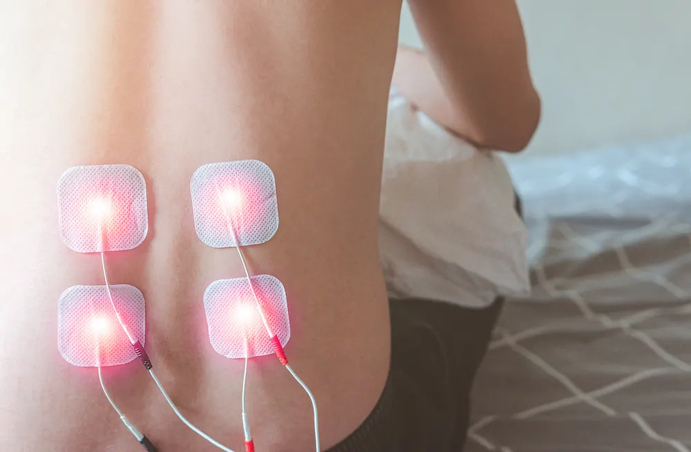 a man having a electrotherapy on his back