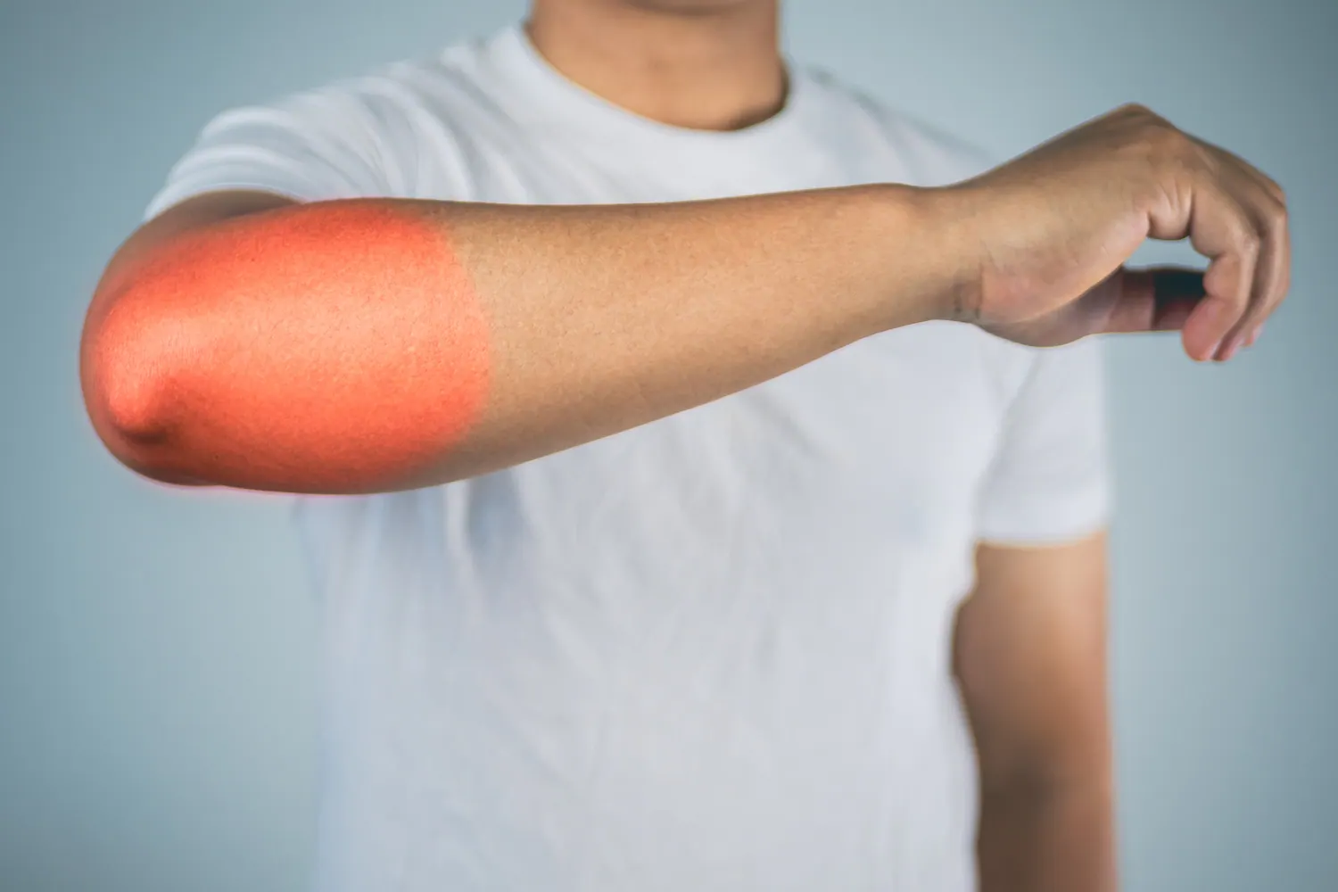 a man suffering from elbow pain