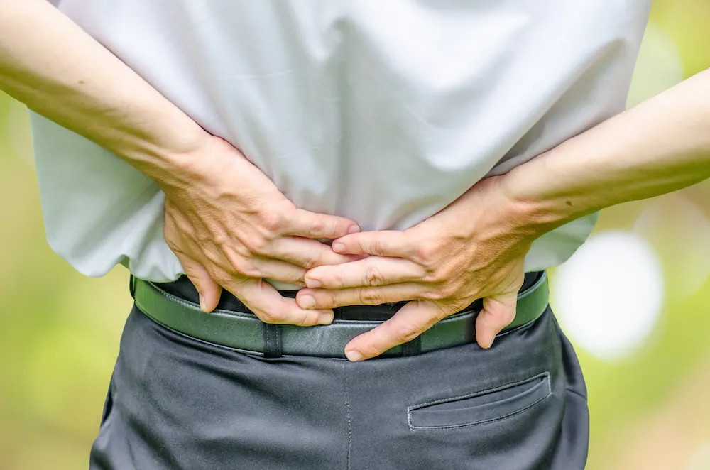a suffering from lower back pain