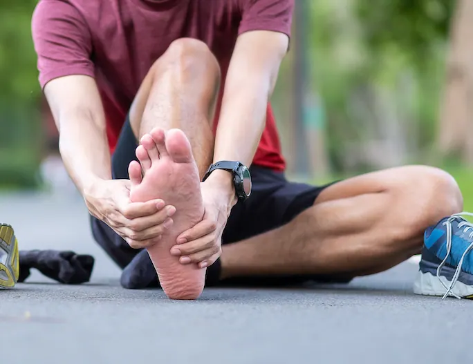 a man suffering from plantar fasciitis after jogging