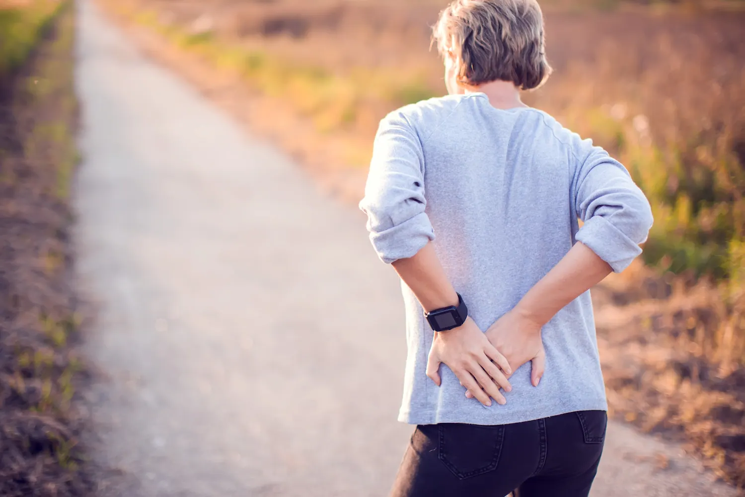 a woman having a hip pain while walking