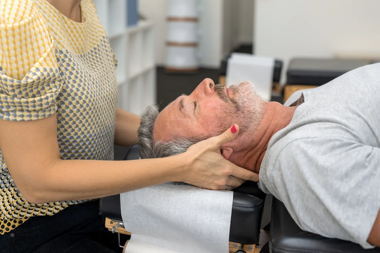 a old man having a neck adjustment