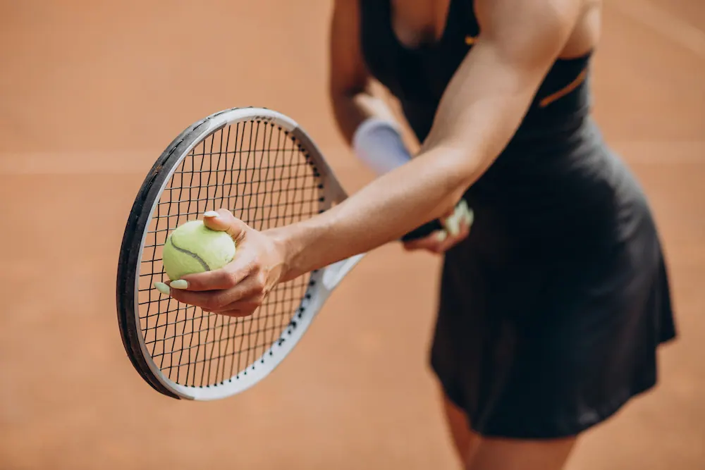 a woman playing tennis with elbow overuse injury
