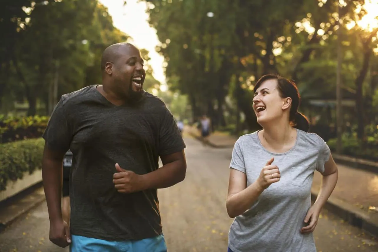 the two partner jogging and laughing