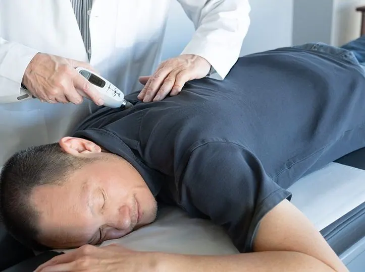 a man having a activator technique on his back