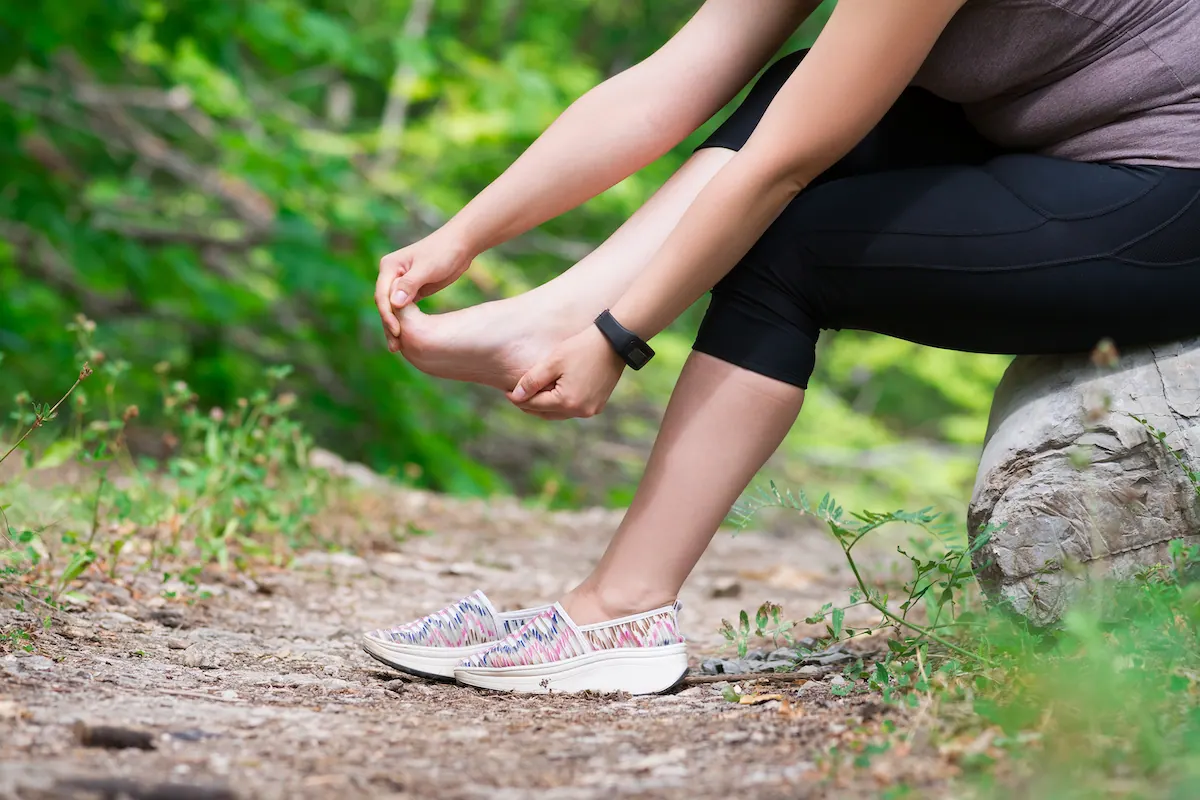 a woman suffering from plantar fasciitis while working
