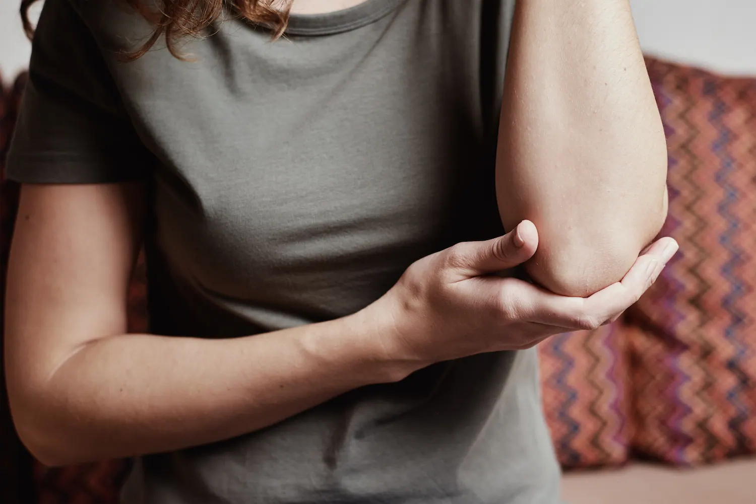 a woman suffering from elbow pain