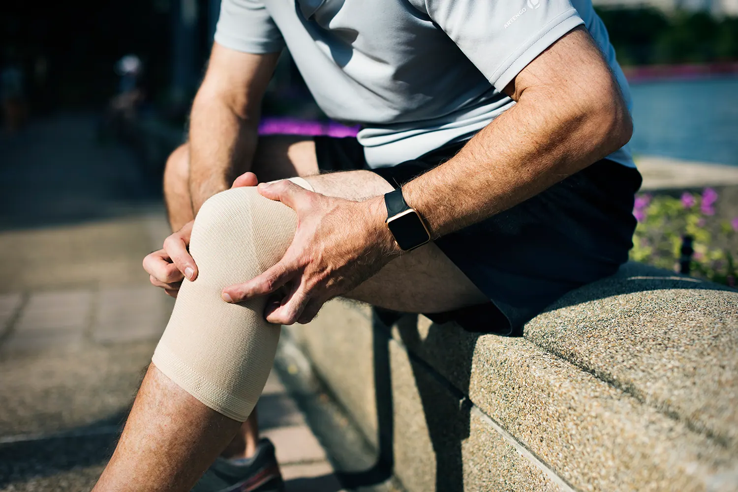a man suffering from knee pain after his jogging