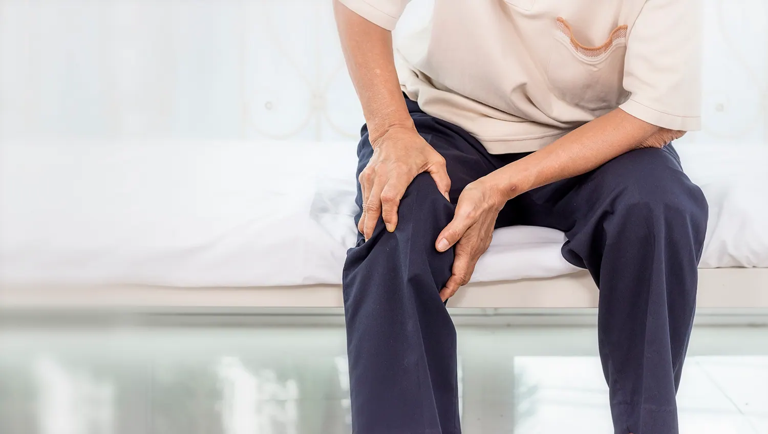 a old man touch his leg pain