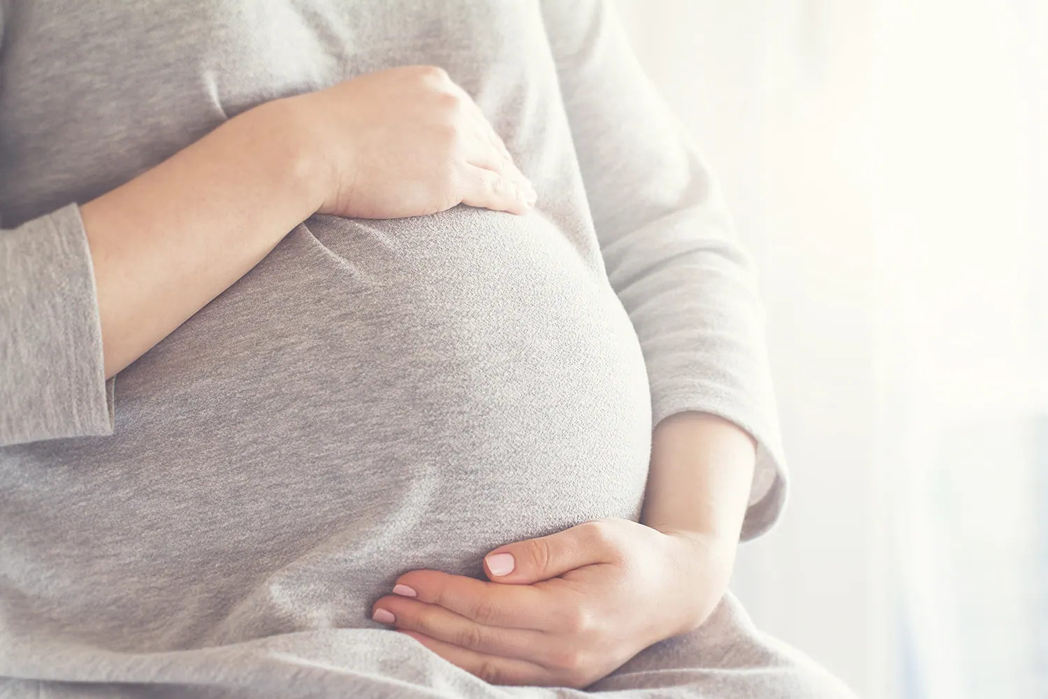 A woman holding her belly