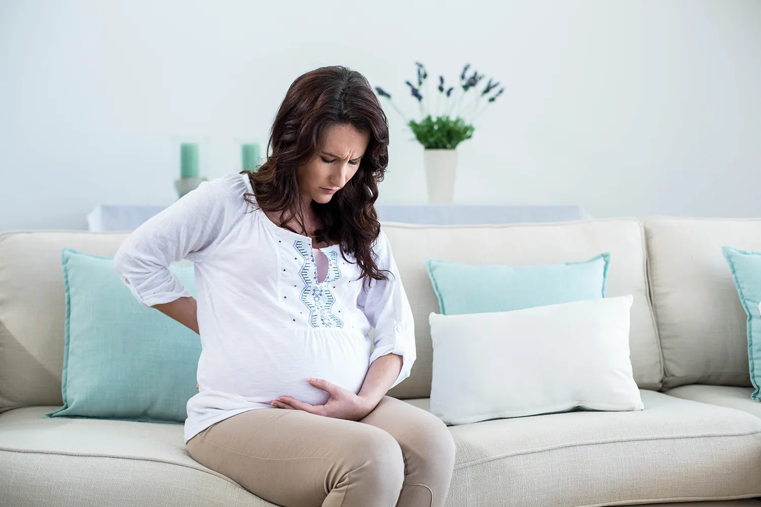 a woman suffering from prenatal pain from pregnancy
