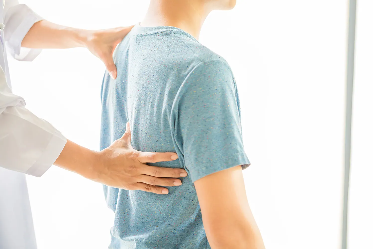 a chiropractor check the back of his patient